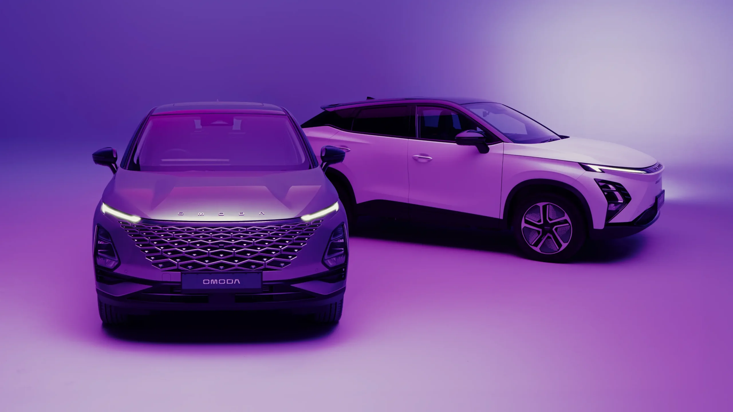 Close up of grey and white OMODA SUVs within a purple environment