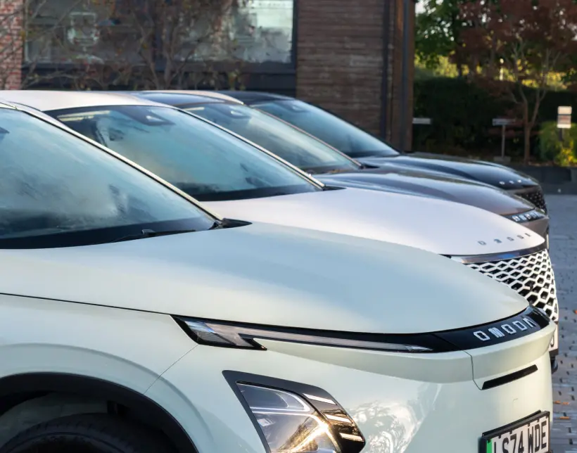 Close up side profile of four OMODA cars