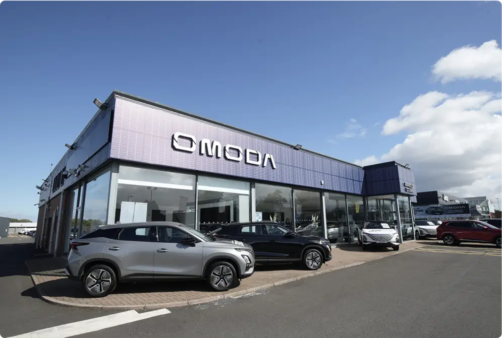 OMODA brand on side of dealership building
