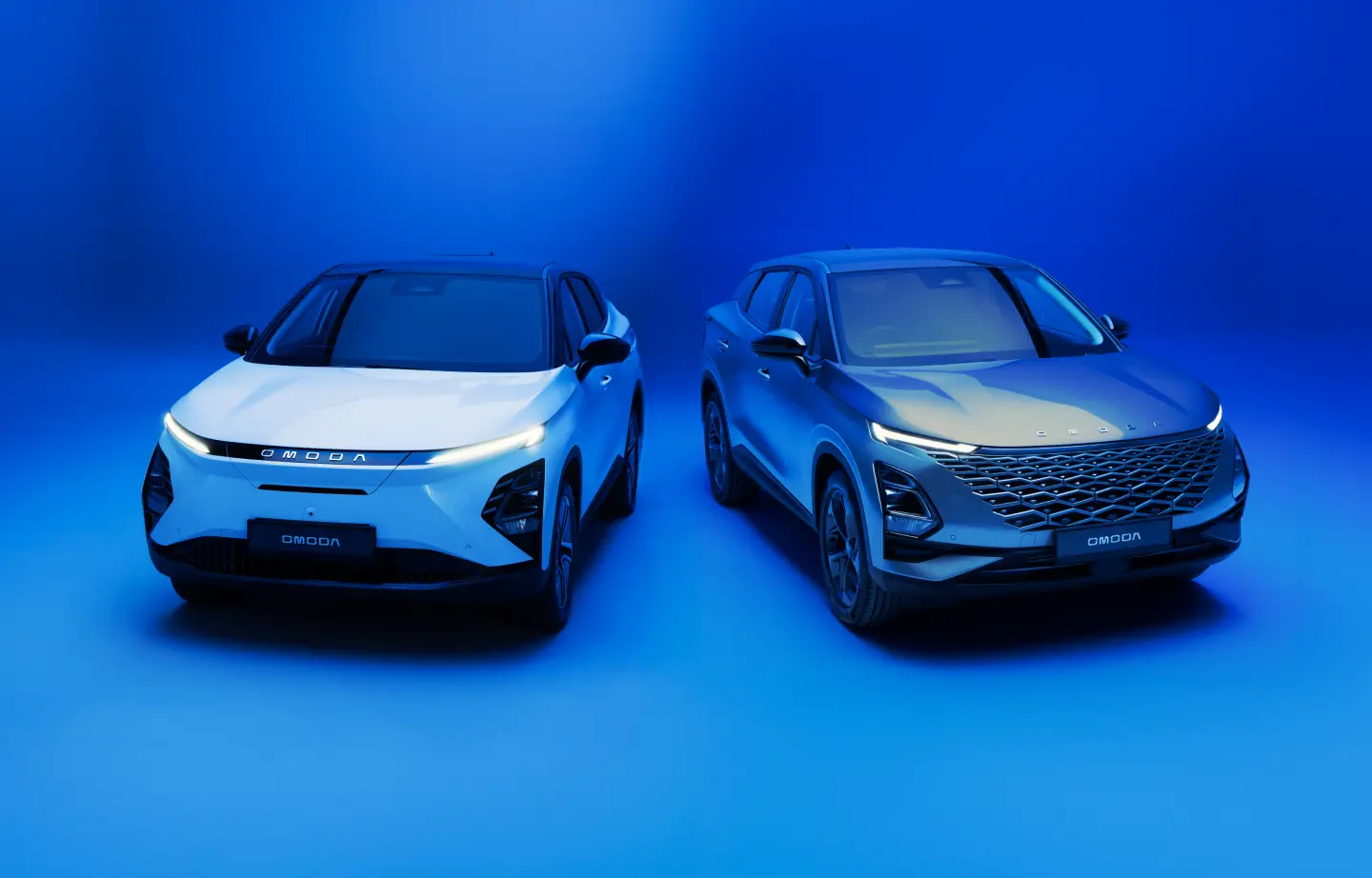 two OMODA cars parked together in blue background