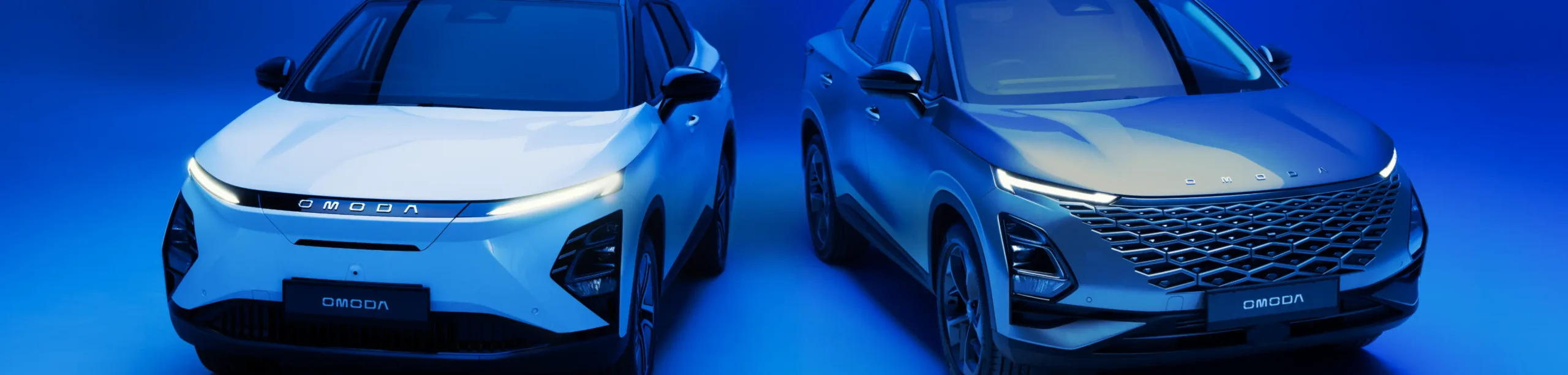 Close up of two OMODA cars in a blue background