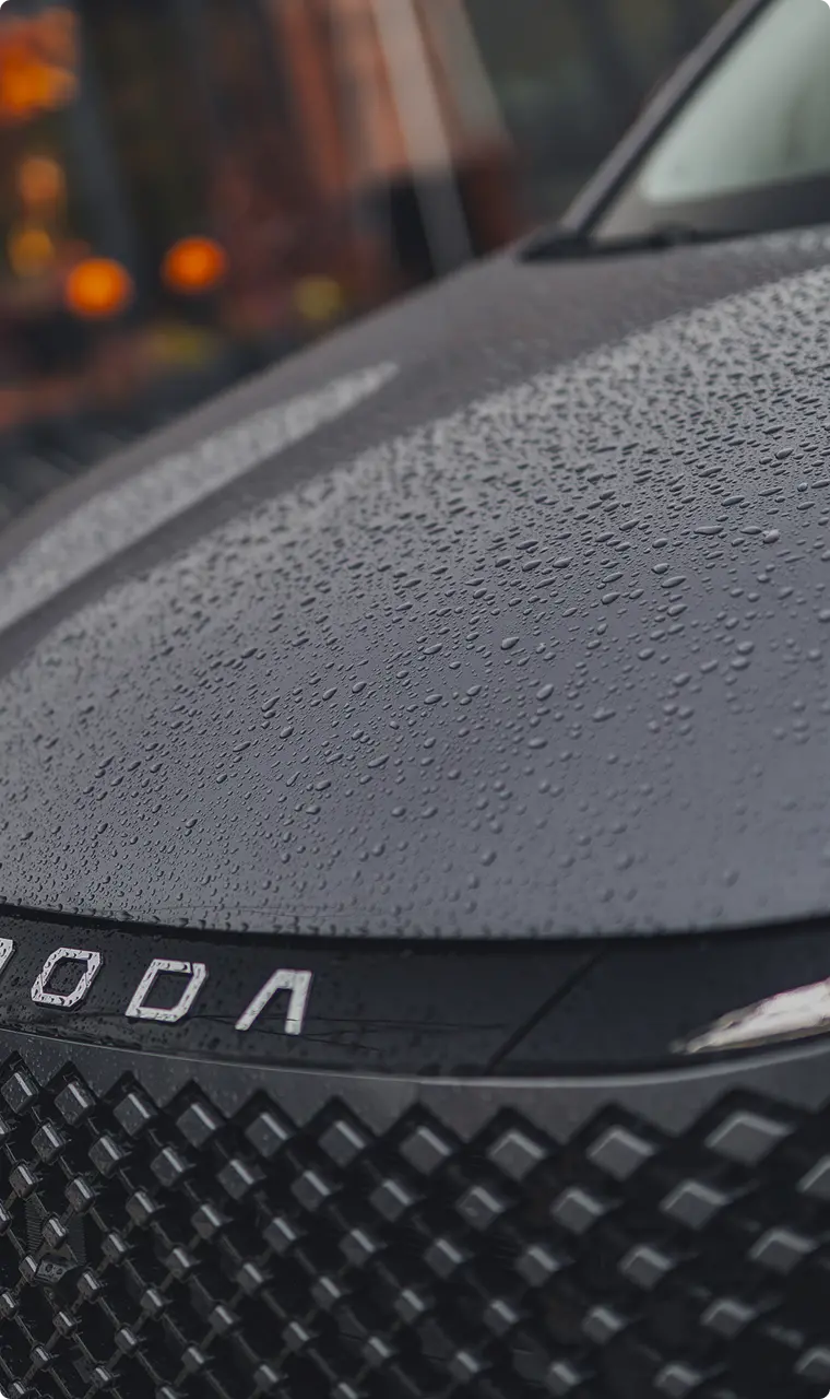 Close up of the OMODA 5 SUV Super Hybrid System with rain drops