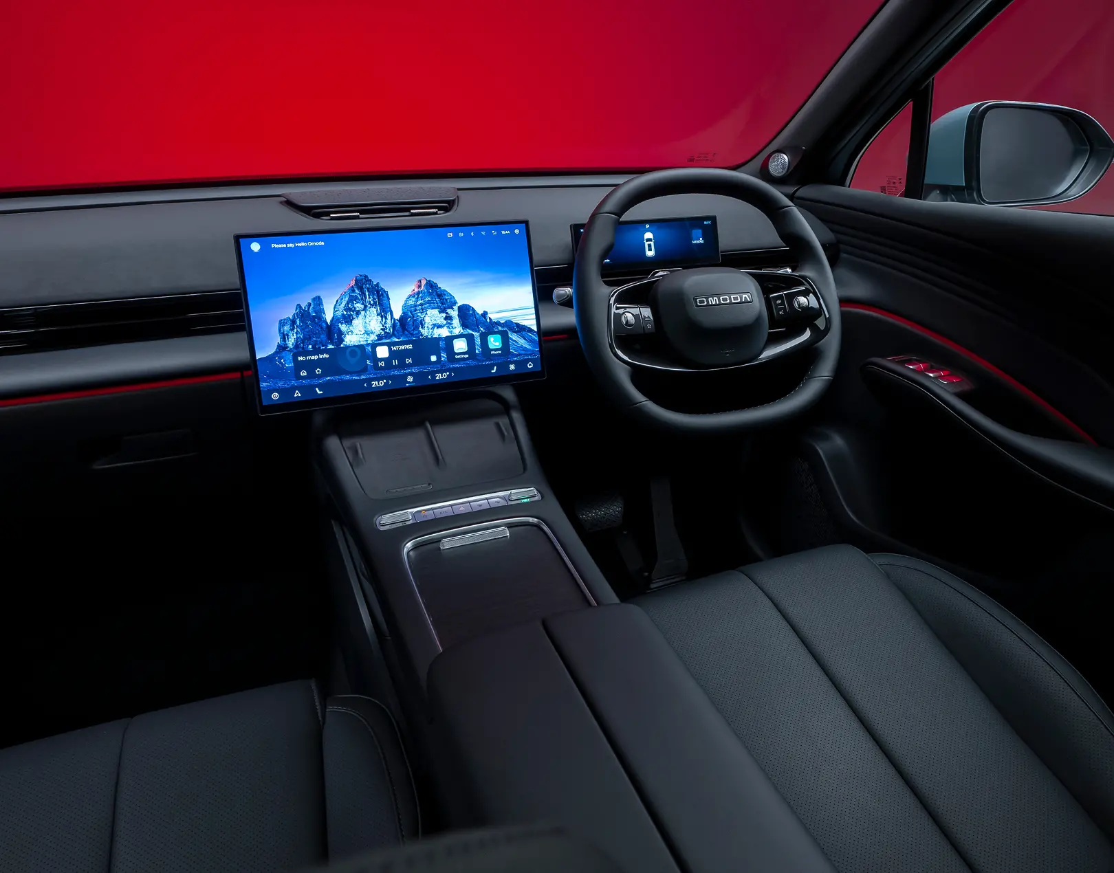 POV of the driver console and steering wheel, detailing all the advanced technology included within an OMODA SUV